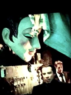 I took this photo off the TV it’s from the movie swordfish with John Travolta and Halle Berry That’s one of cells lost masks they were 300 made I have 110 of them the one you’re looking at has been lost since the 70s when John Travolta walks through a bar it’s hanging on the wall