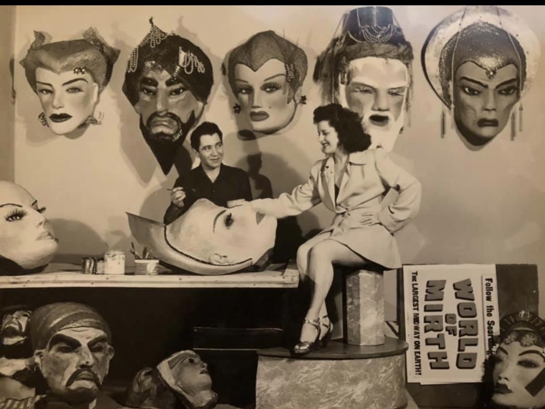 The photo you were looking at is one of Sal Studios when he traveled with the world the mirth bazaar traveling carnival in 1949 the mask on the wall we’re all made in the mid 30s they always have been used for Sal‘s mind Reading act and hypnotizing people the three masks in the middle are still in existence today the two on the right or at our house here in Florida with 65 other ones what’s unique about them is the special ingredients in their papier-mâché mix pyramids scrapings from Egypt, Haitian voodoo dust. Cambodian opium, and secret potions from around the world I’ll tell you what these masks have powers the second one from the left that looks like Aladdin was giving to my great uncle Lou his daughters have him There are stories flying around about him wild stories