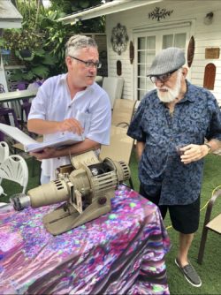 That’s my dad with the hat on and my partner mr. Kerry Martin We are setting up for one of my Key West slideshow parties at CW‘s house that’s one of Sal‘s original projectors with all the portraits he shot above Captain Tony’s in the 60s and 70s back then he did a musical slideshow at the bar why he played the piano I didn’t play the piano But I showed his work I also had another projector from all my published photos in Key West from the 70s and 80s we had three of these parties in Key West I had a lot of fun Explaining which each photo was I was like a photo DJ we hope to be doing more of these very soon